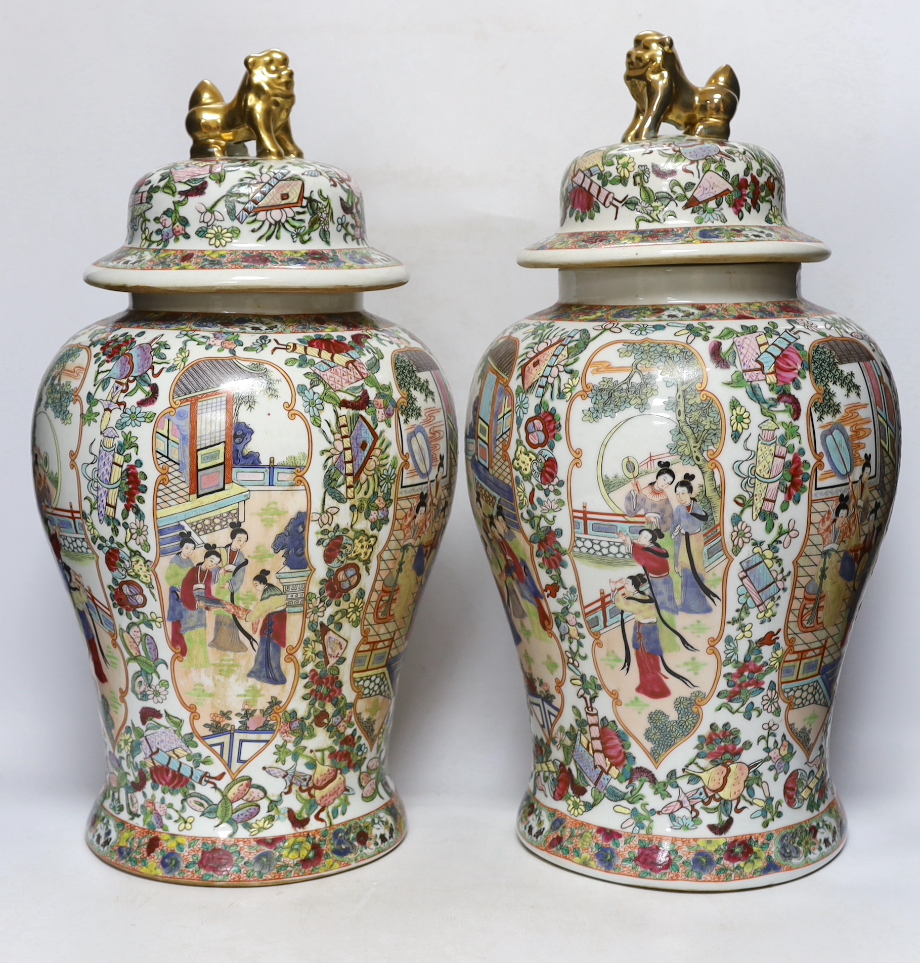 A pair of Chinese famille rose lidded vases, 49cm high